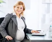 Portrait of pregnant business woman. She is working on a laptop in her office, and looking at camera. 

[url=http://www.istockphoto.com/search/lightbox/9786622][img]http://dl.dropbox.com/u/40117171/business.jpg[/img][/url]