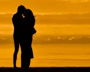 Lovers embracing on the beach at sundown on Morro Strand State Beach