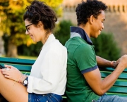 Happy Young Italian Couple using Digital Tablet and Mobile Phone