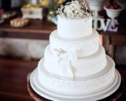 4 tier round white wedding cake with white bow and sewing Best of 4 tier round wedding cakes