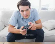Man playing video games while he is sat on a sofa