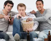 Three male friends watching television together