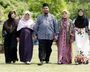In this  Aug. 15, 2009 photo, polygamist Mohammad Inaamulillah Bin Ashaari, center, is shown with his four wives, from left, Rohaiza Esa, Ummu Habibah Raihaw , Nurul Azwa Mohd Ani,and Ummu Ammarah Asmis at the "Ikhwan Polygamy Club Family Day" in Rawang, north of Kuala Lumpur, Malaysia. Polygamy is legal for Muslims in Malaysia, though not widespread. The Ashaari clan believes it should be. Last month, the sprawling family launched a Polygamy Club that seeks to promote plural marriages for what it says are noble aims, such as helping single mothers, prostitutes and older women find husbands. (AP Photo/Mark Baker)