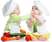 children boy and girl wearing a chef hat with healthy  food vegetables