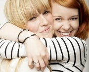 red and blond haired girls laughing and hug