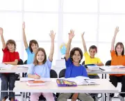 School children raising hands in a modern classroom.