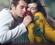 Young couple with rose, outdoors